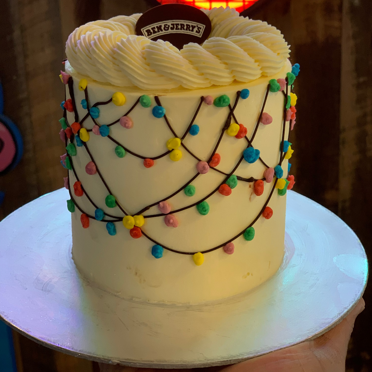 Front view of a Christmas lights-themed cake made with Ben & Jerry's ice cream in Adelaide, showcasing its cheerful holiday-inspired design.