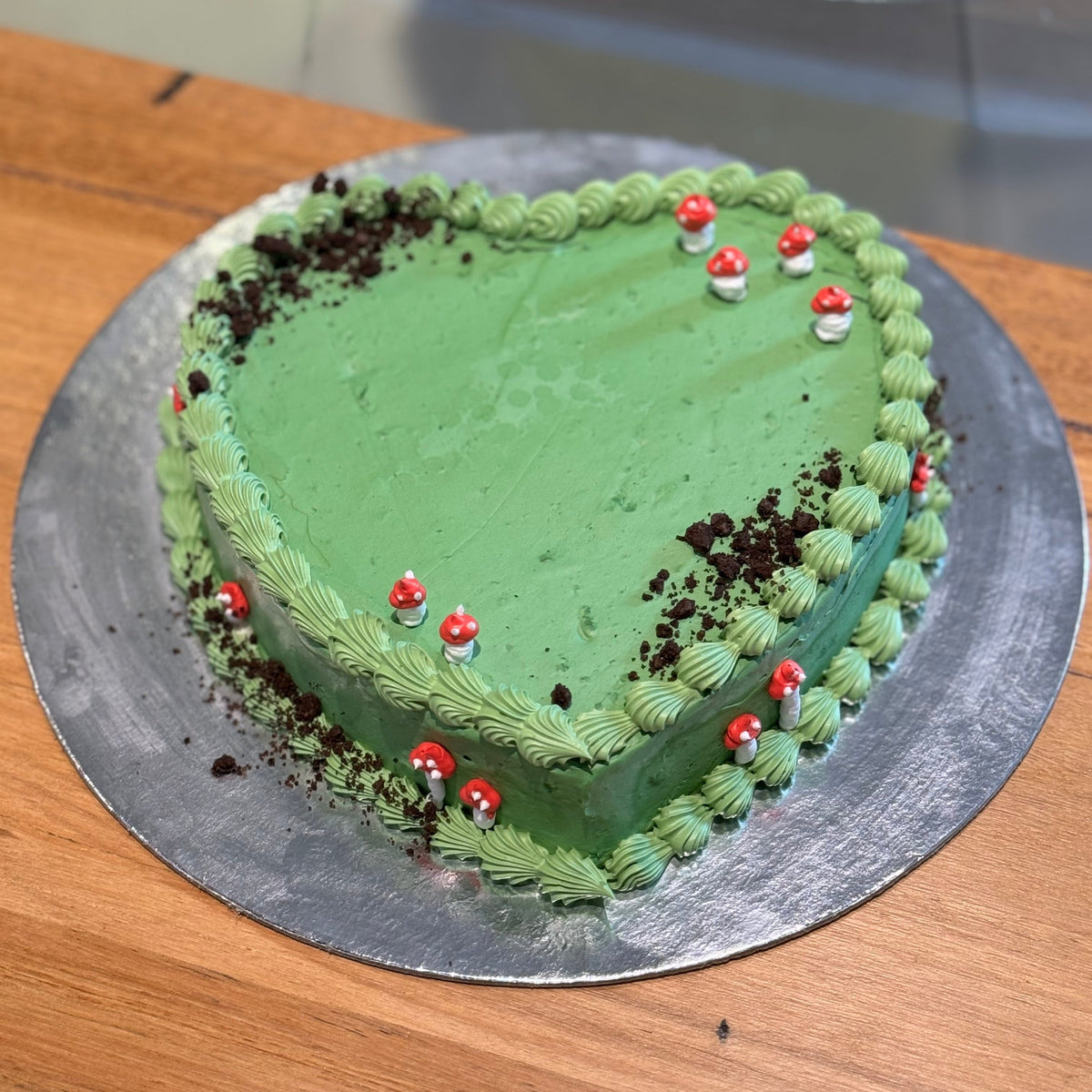 top view of a handcrafted forest mushroom heart cake in Adelaide made using Ben & Jerry's ice cream, highlighting its woodland-themed styling.