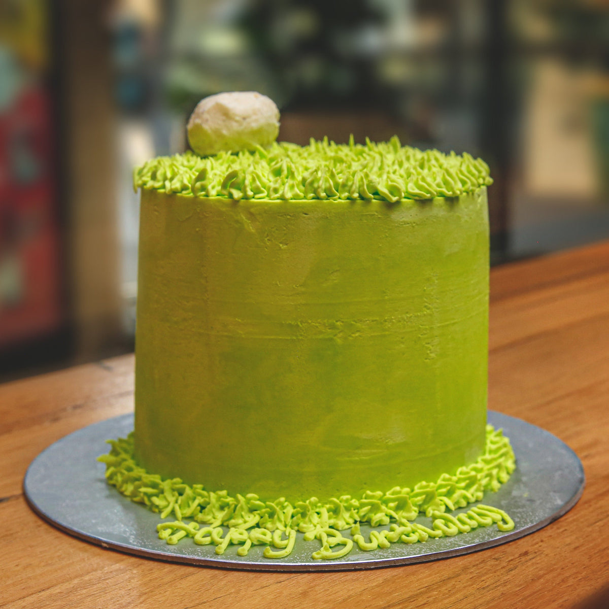 front view of golf-inspired decorations on a handcrafted tall ice cream birthday cake for golf enthusiasts.