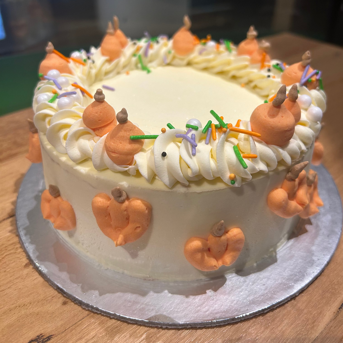 Front view of a Halloween pumpkin birthday cake made with Ben & Jerry's ice cream in Adelaide, showcasing its playful spooky-season styling.