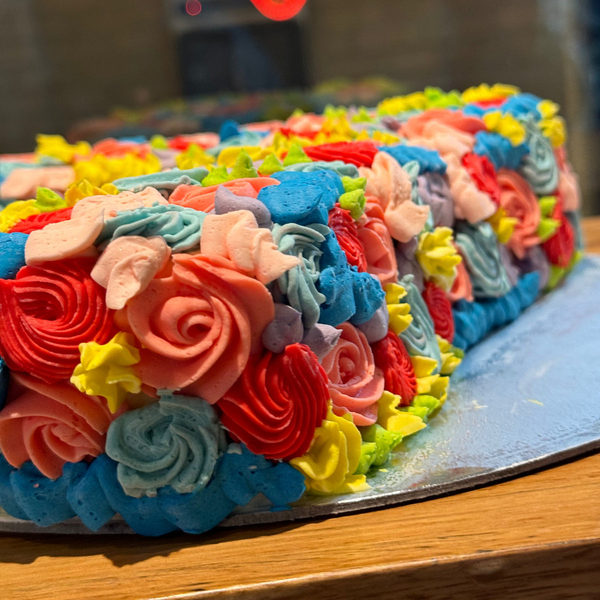 Close-up view of the decorative details on a number 7-shaped ice cream cake for a seventh birthday celebration.