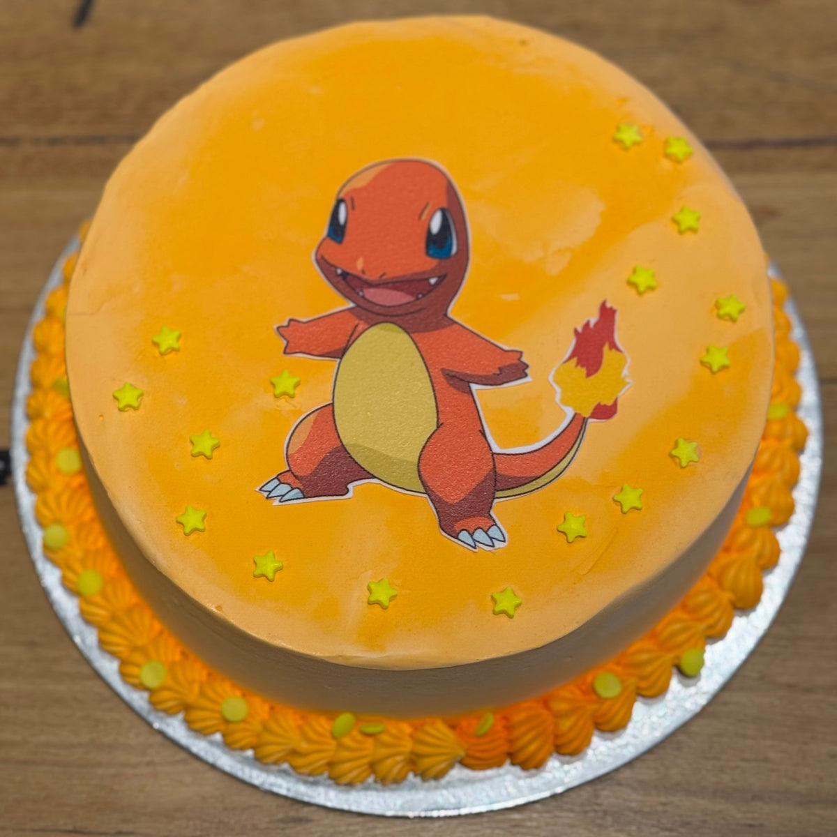 top view of a Pokémon Charmander ice cream cake handcrafted in Adelaide using Ben & Jerry's ice cream, highlighting its vibrant orange styling.