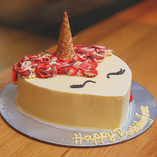 side view of a unicorn heart ice cream cake showcasing its charming heart-shaped design and magical unicorn-themed decorations.