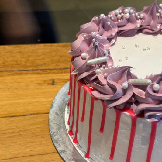 side view of a pastel vintage cake made with Ben & Jerry's ice cream in Adelaide, showcasing decorative piping and pearl embellishments.