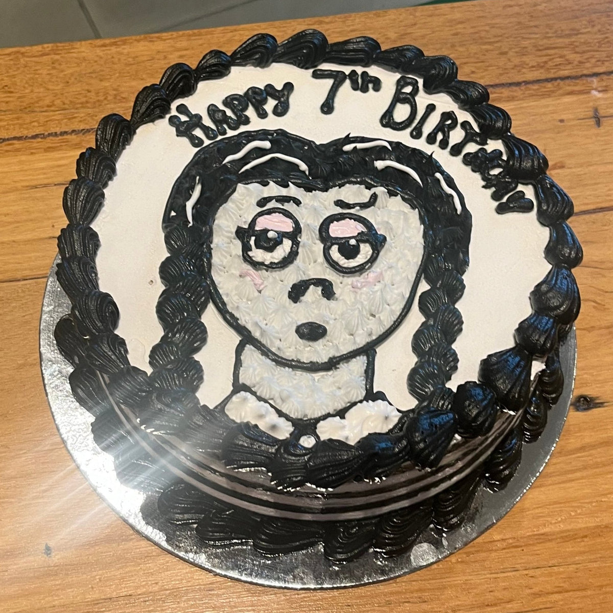 Full view of a Wednesday Addams-themed birthday cake handcrafted in Adelaide using Ben & Jerry's ice cream, featuring a spooky gothic-inspired design.