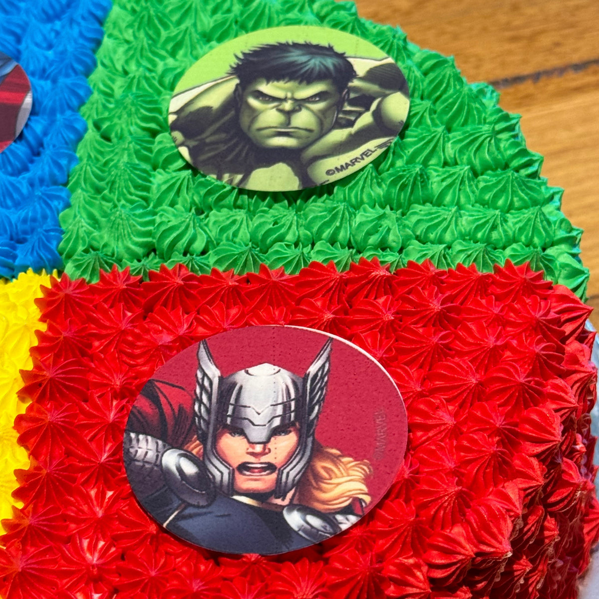 close up of a handcrafted Avengers birthday cake highlighting its superhero-inspired colours and decorative finish.