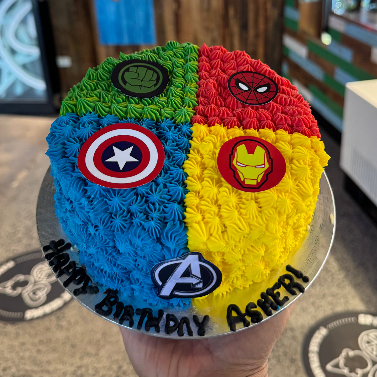top view of an Avengers ice cream cake highlighting the vibrant superhero-themed details and colourful birthday decorations.