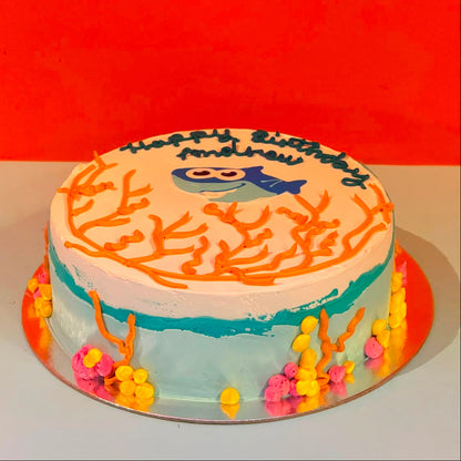 Full view of a Baby Shark birthday cake handcrafted in Adelaide using Ben & Jerry's ice cream, featuring a playful underwater-themed design.