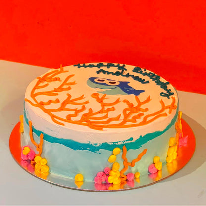 Side view of a handcrafted Baby Shark ice cream cake made using Ben & Jerry's ice cream in Adelaide, highlighting its playful birthday presentation.