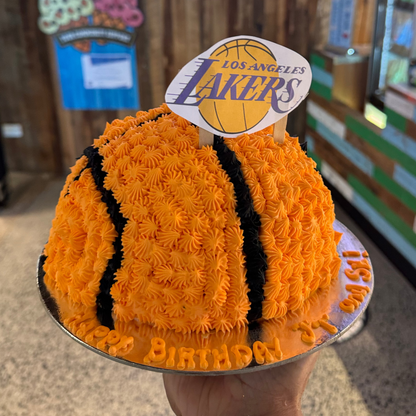 Front view of a dome-shaped basketball birthday cake handcrafted in Adelaide using Ben & Jerry's ice cream, featuring a realistic rounded basketball design.