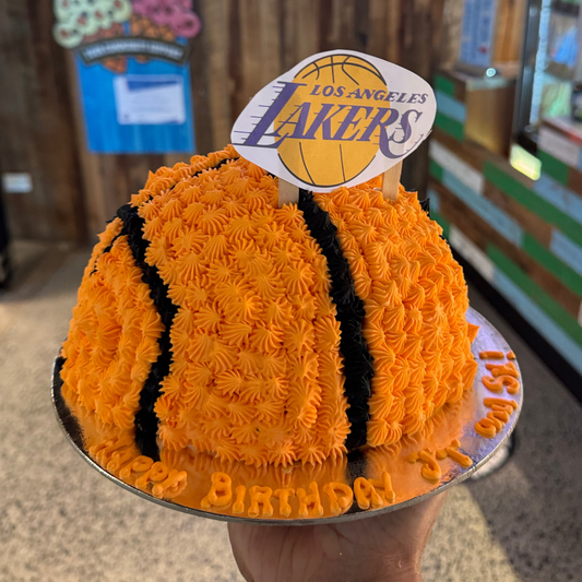 Front view of a dome-shaped basketball birthday cake handcrafted in Adelaide using Ben & Jerry's ice cream, featuring a realistic rounded basketball design.