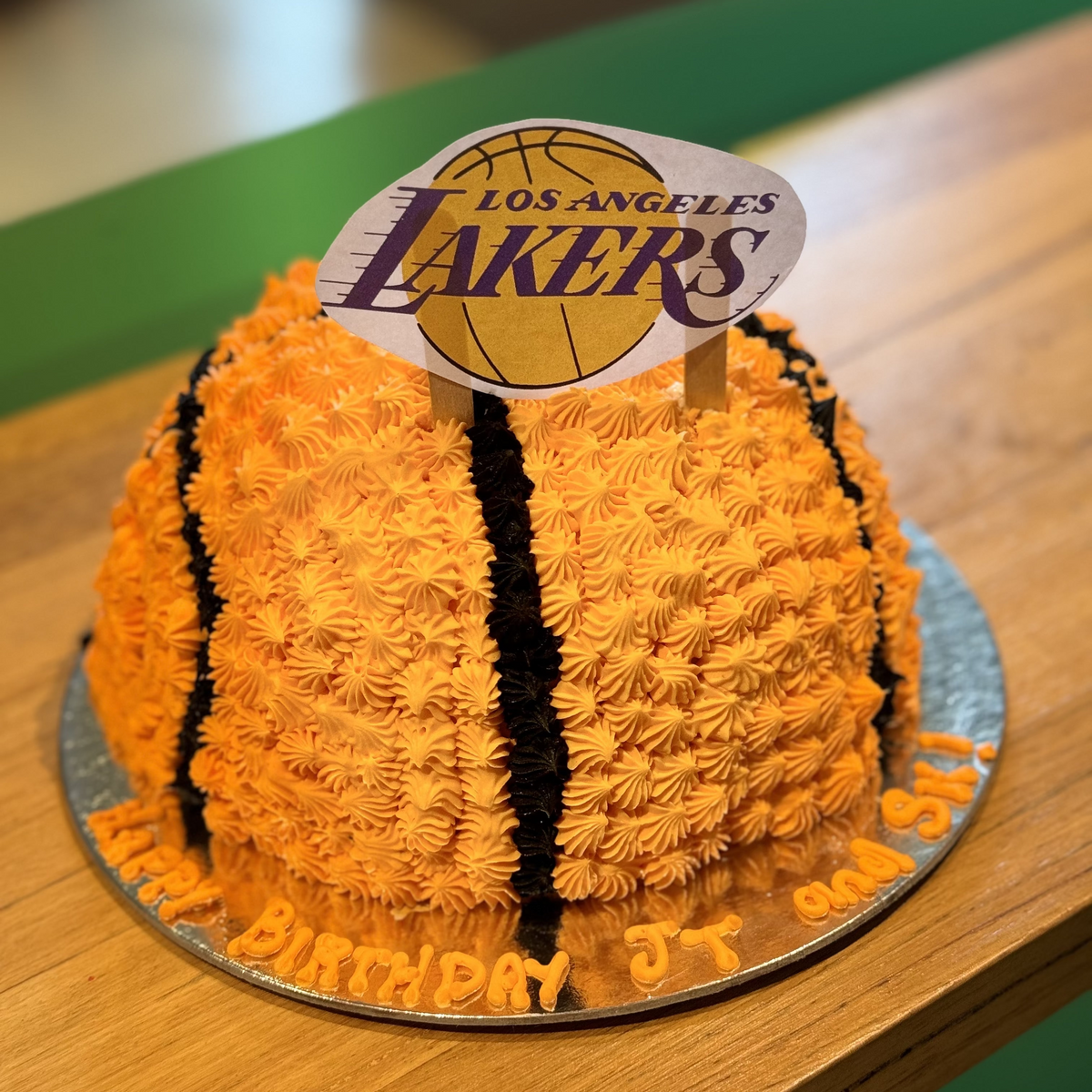 front view of a handcrafted basketball dome cake made with Ben & Jerry's ice cream in Adelaide, highlighting its raised, rounded shape.