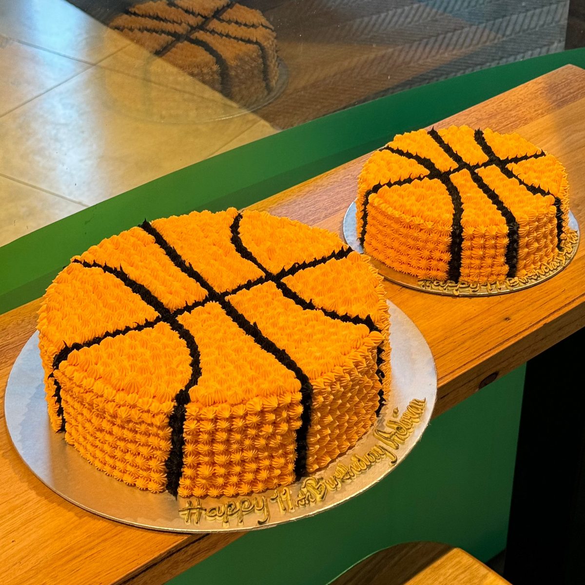 Front view of a basketball-themed birthday cake made with Ben & Jerry's ice cream in Adelaide, showcasing its orange basketball design and black line details.