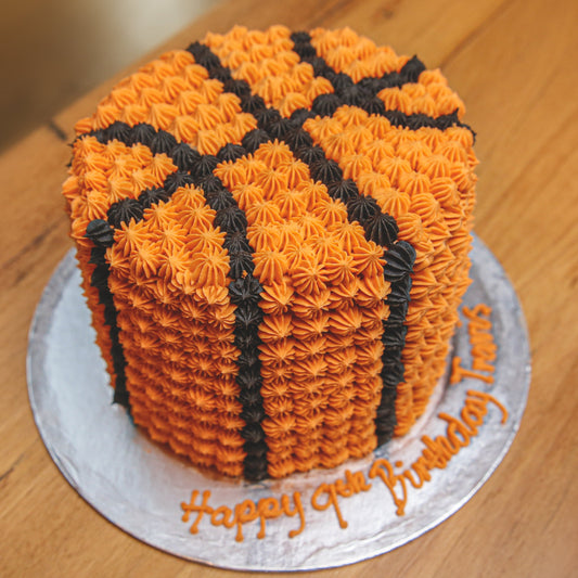 top view of a handcrafted tall basketball ice cream cake showcasing its basketball-themed styling for a sports birthday party.