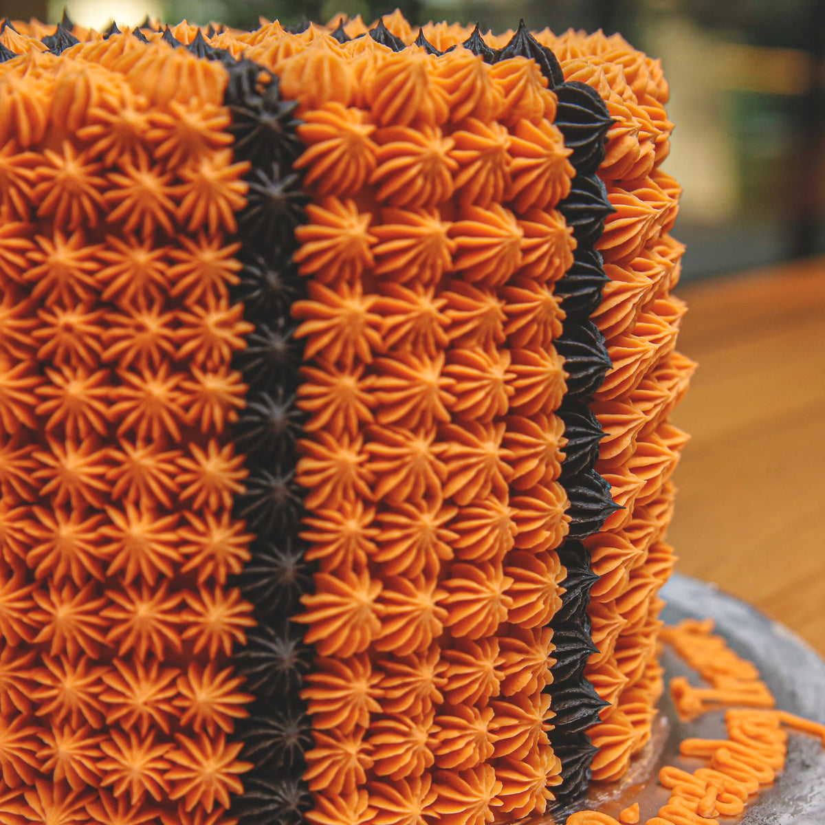 Close-up view of basketball-inspired decorative details on a handcrafted tall birthday ice cream cake.