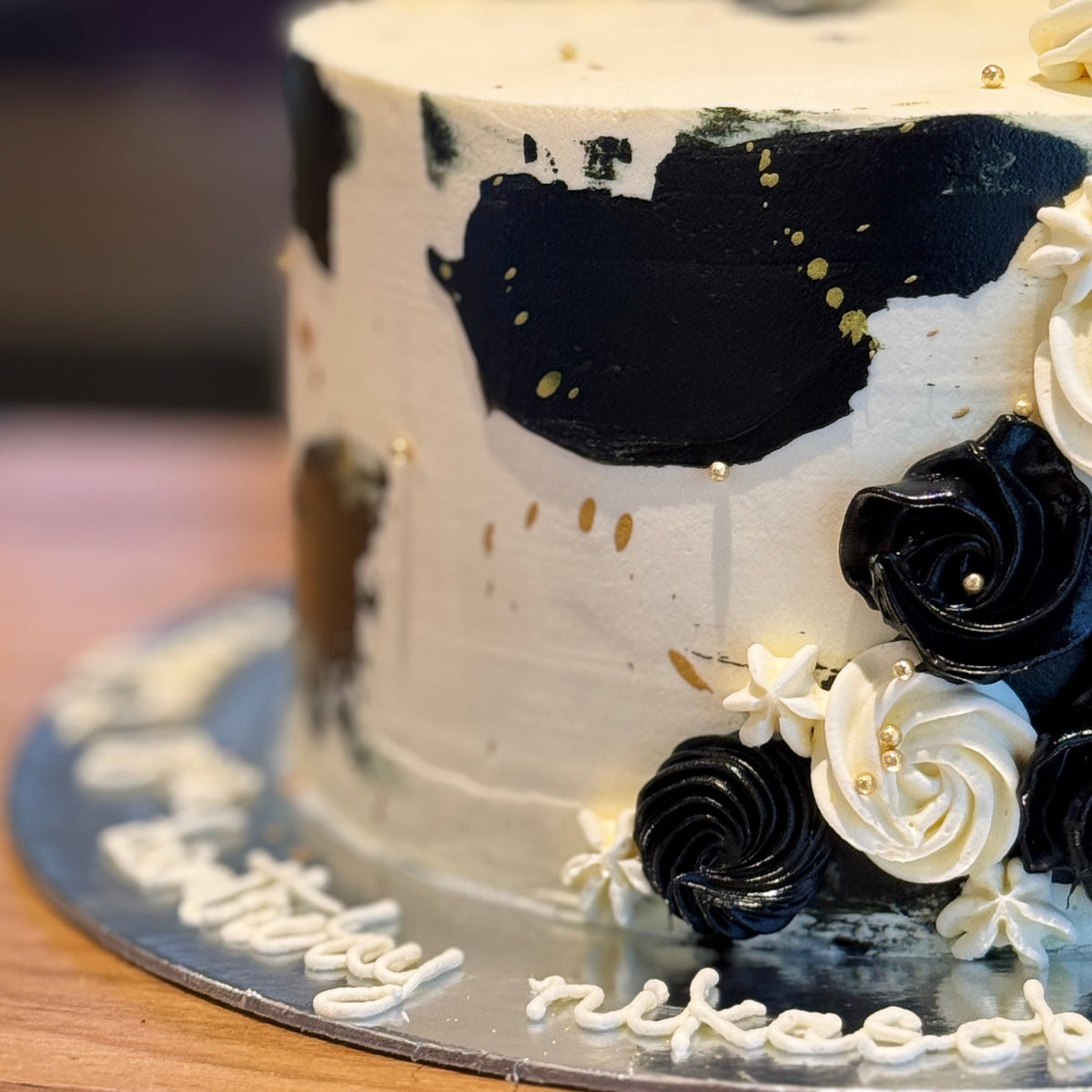 close up of a handcrafted mud or sponge cake in Adelaide, highlighting its cascading decorative details and luxurious gold styling.