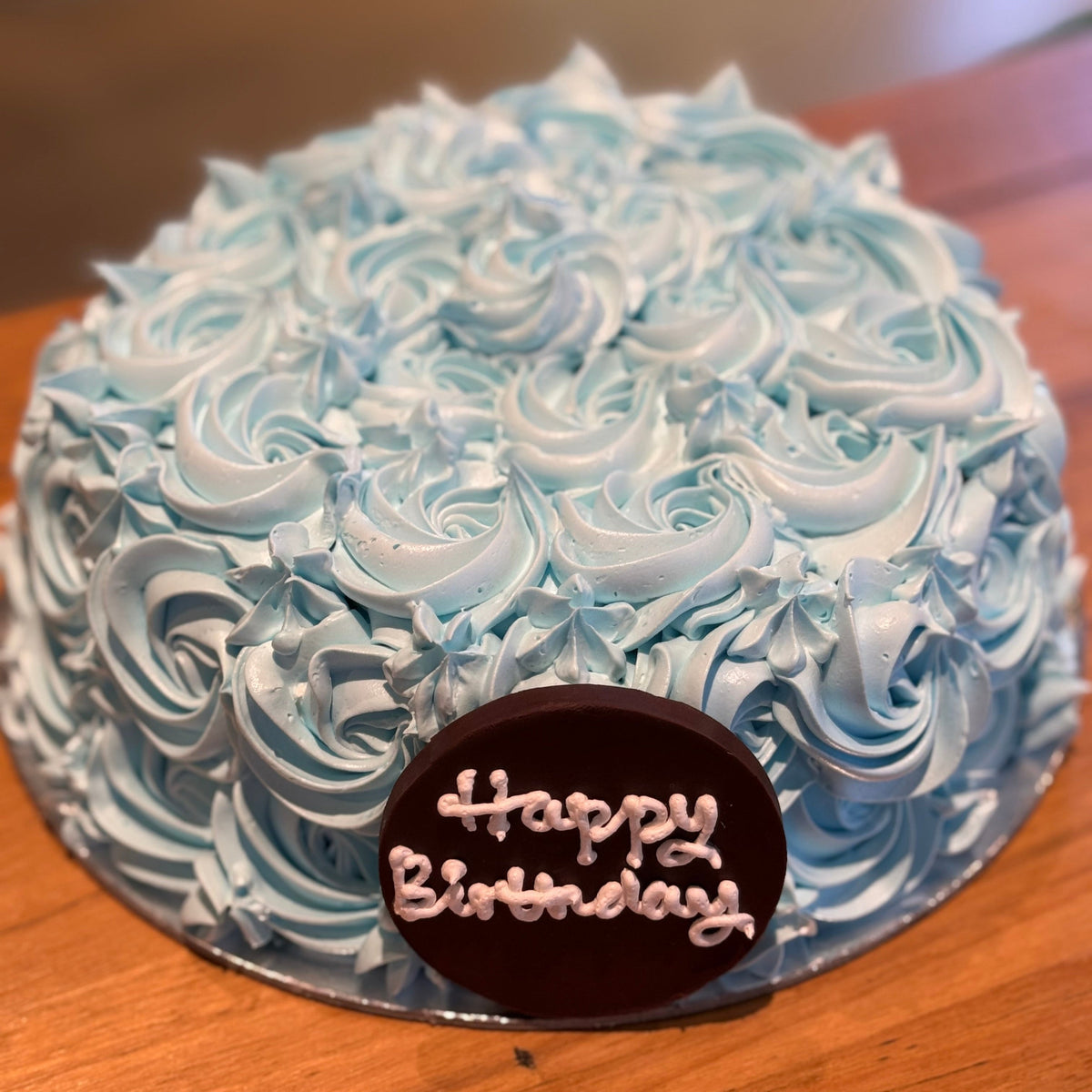 top view of the decorative blue rosette piping on a cake handcrafted in Adelaide using Ben & Jerry's ice cream.