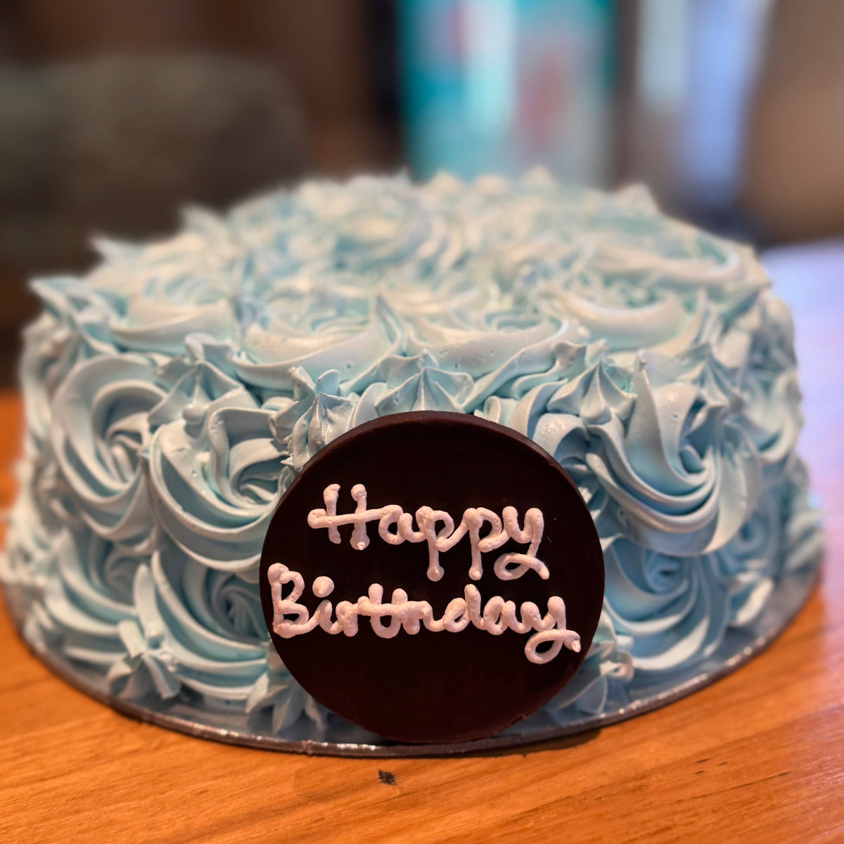 front view of a blue rosette ice cream cake made using Ben & Jerry's ice cream in Adelaide, highlighting its textured floral finish.