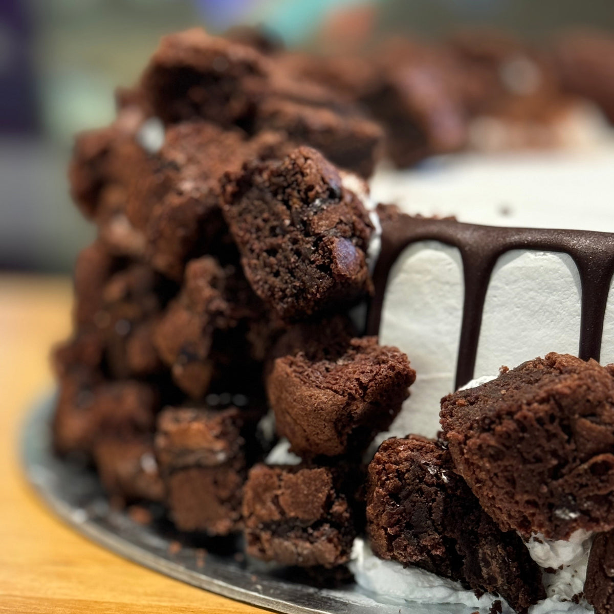 Close-up of delicious brownie pieces decorating a chocolate-inspired cake handcrafted in Adelaide using Ben & Jerry's ice cream.