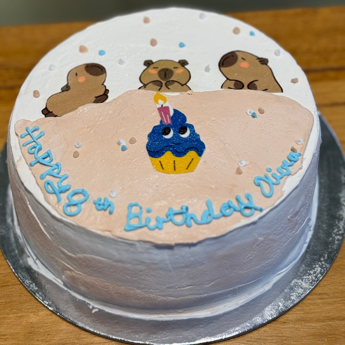 top view of a cute capybara celebration cake handcrafted in Adelaide using Ben & Jerry's ice cream, featuring playful animal-themed decorations.