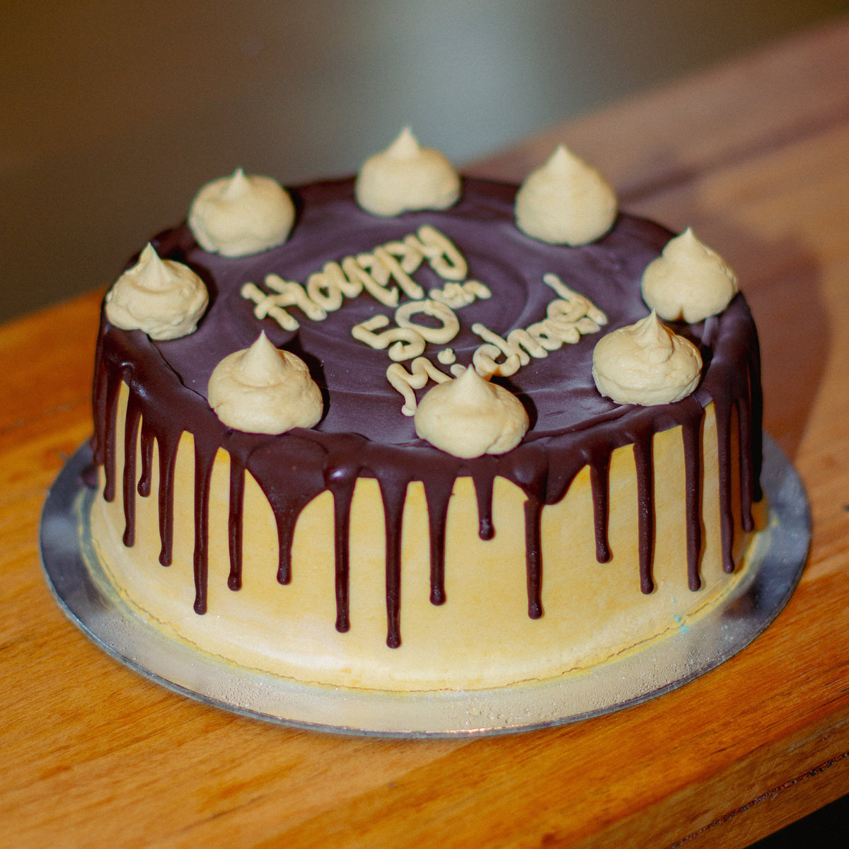 Full view of a caramel fudge drizzle ice cream cake featuring a rich caramel and chocolate-inspired finish for birthday celebrations.