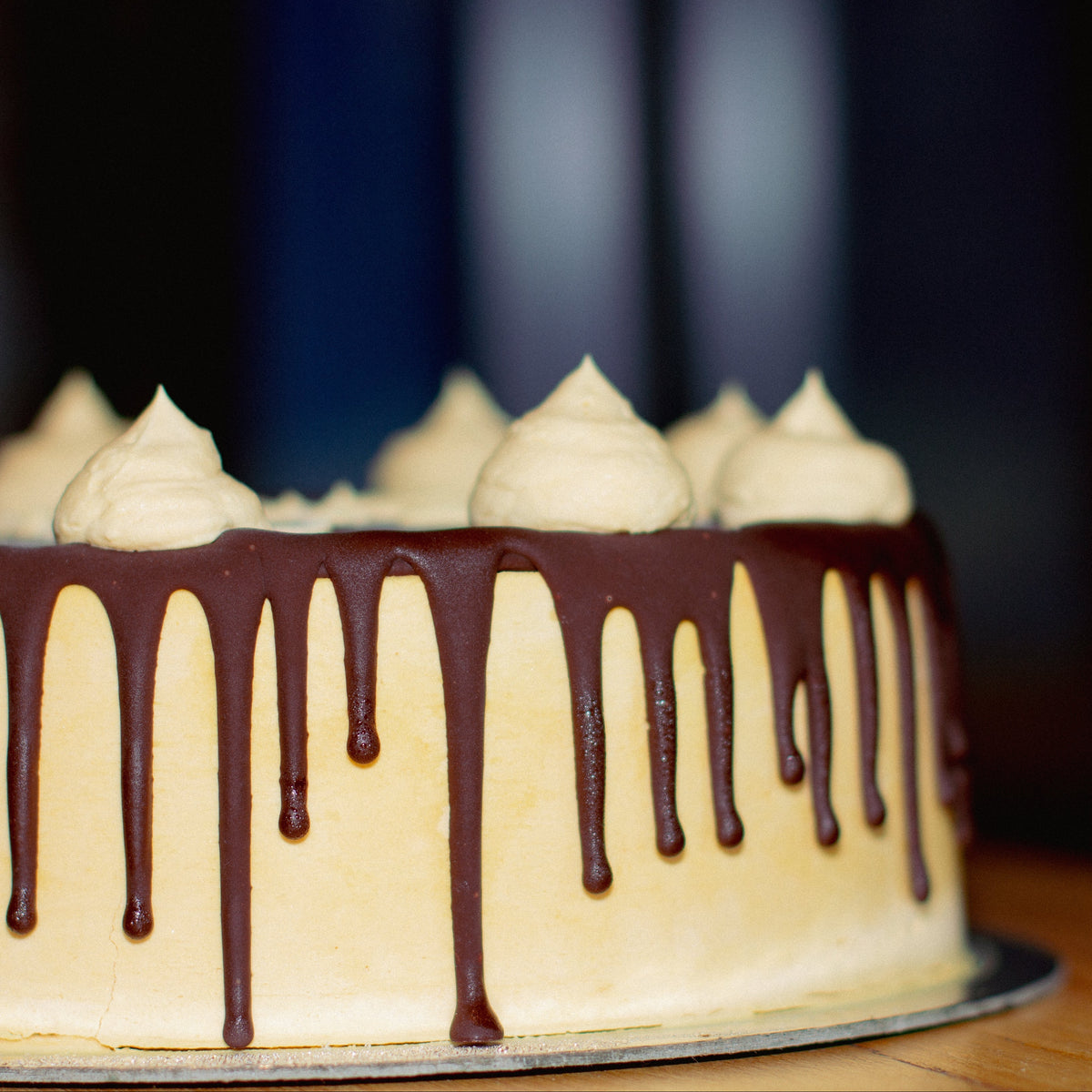close up of a handcrafted caramel fudge ice cream cake highlighting the flowing drizzle details along its outer finish.