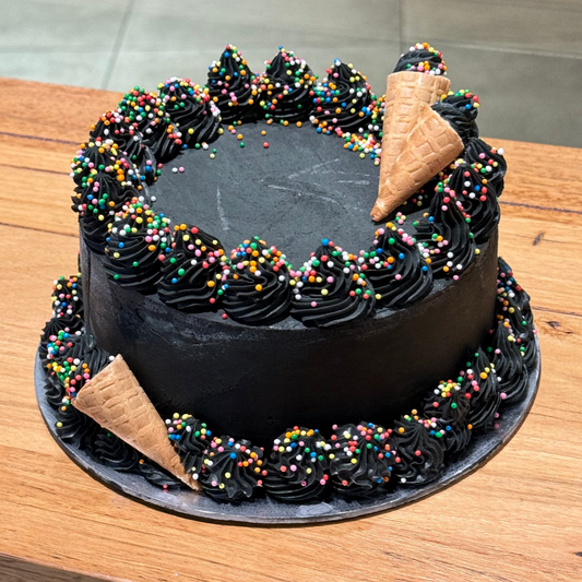 Full view of Celebrations Cake Design #6, a black-themed birthday cake handcrafted in Adelaide using Ben & Jerry's ice cream.