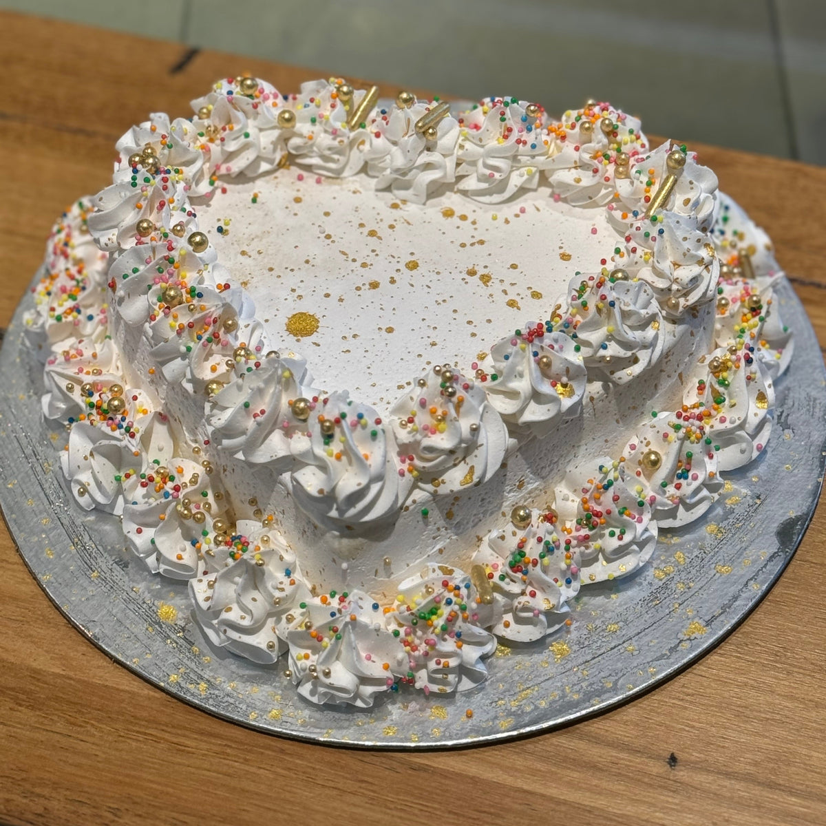 Full view of a gold dust heart-shaped celebration cake handcrafted in Adelaide using Ben & Jerry's ice cream, featuring shimmering golden accents.