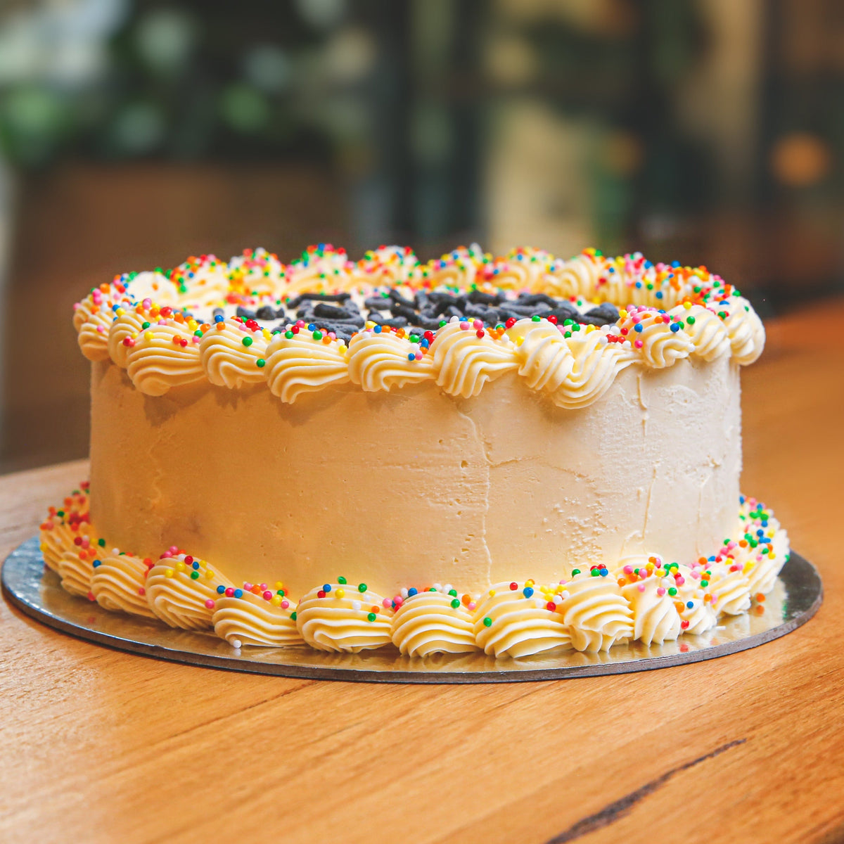 Front view of a celebration birthday ice cream cake showcasing the cone-free decorative styling of Design 3.