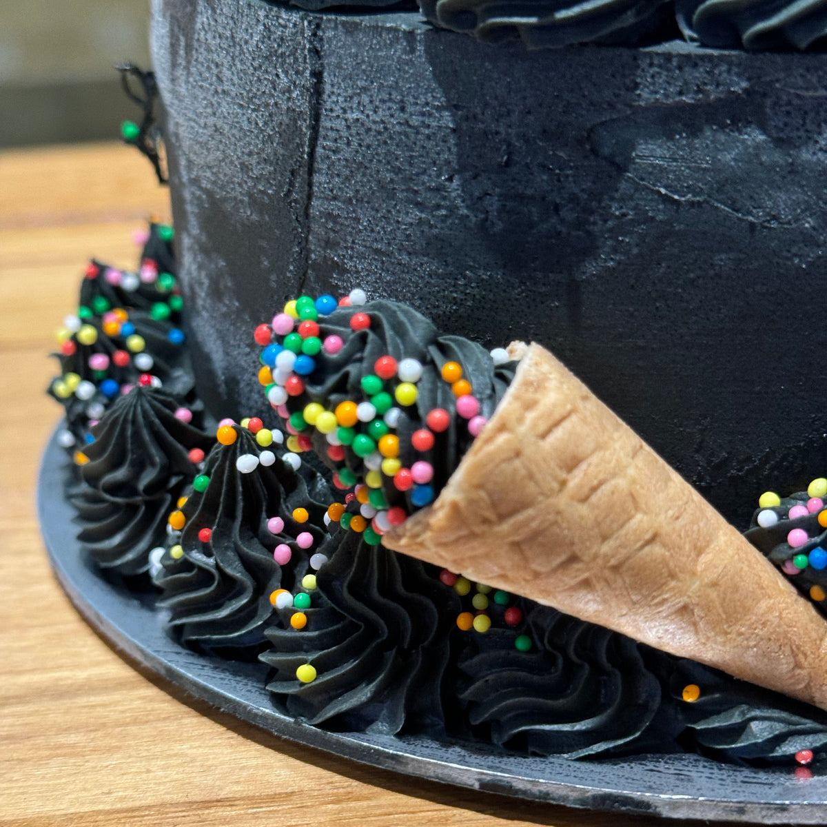 Close-up of the dark decorative finish on Celebrations Cake Design #6, handcrafted in Adelaide using Ben & Jerry's ice cream.