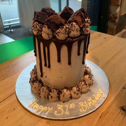 Full view of a tall chocolate fudge brownie-themed cake handcrafted in Adelaide using Ben & Jerry's ice cream, featuring indulgent chocolate-inspired styling.