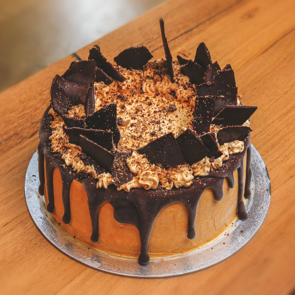 Full view of a handcrafted chocolate shard birthday ice cream cake featuring decorative chocolate pieces for an indulgent celebration.
