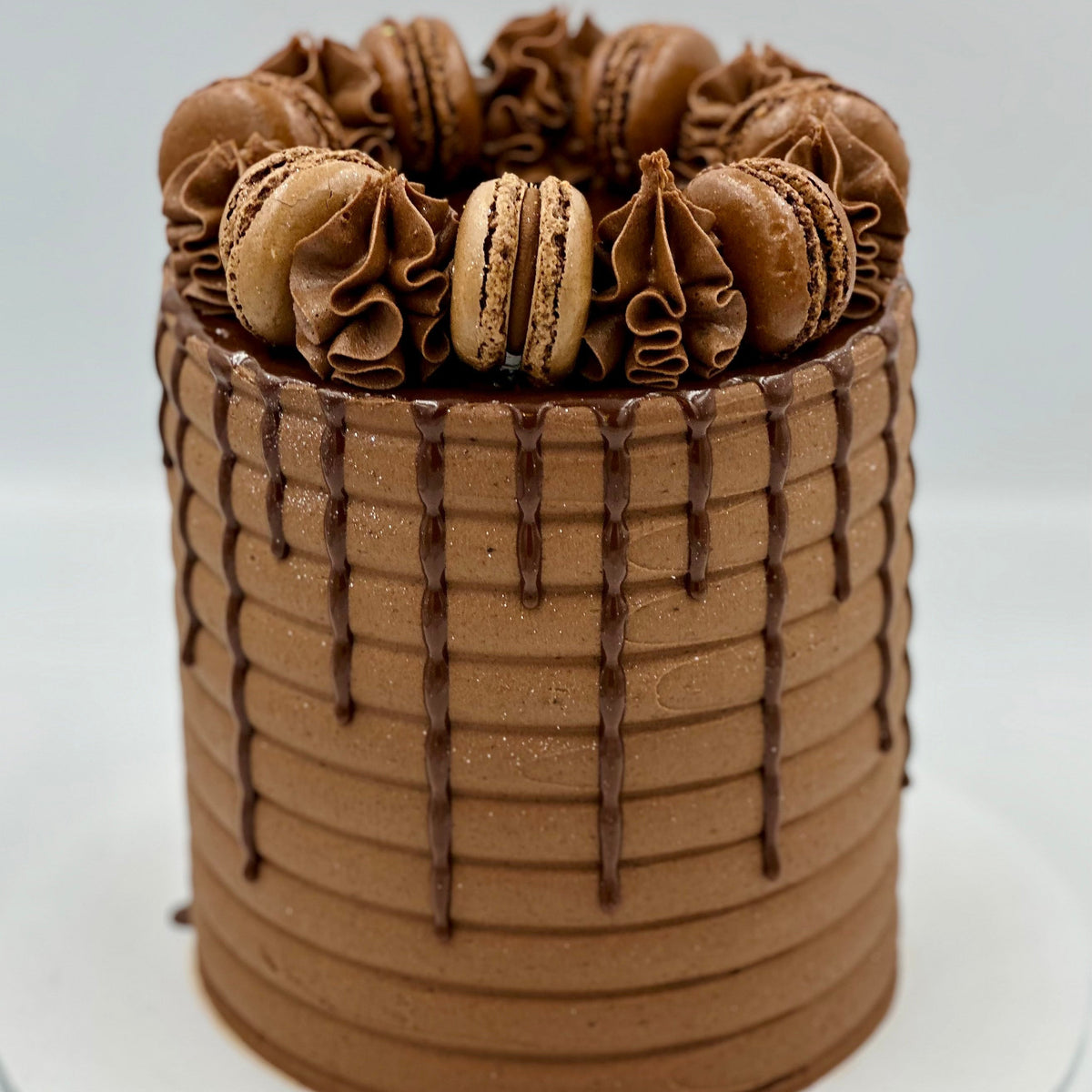 Full view of a chocolate macaron celebration cake handcrafted in Adelaide, featuring an elegant chocolate-inspired finish and decorative macarons.