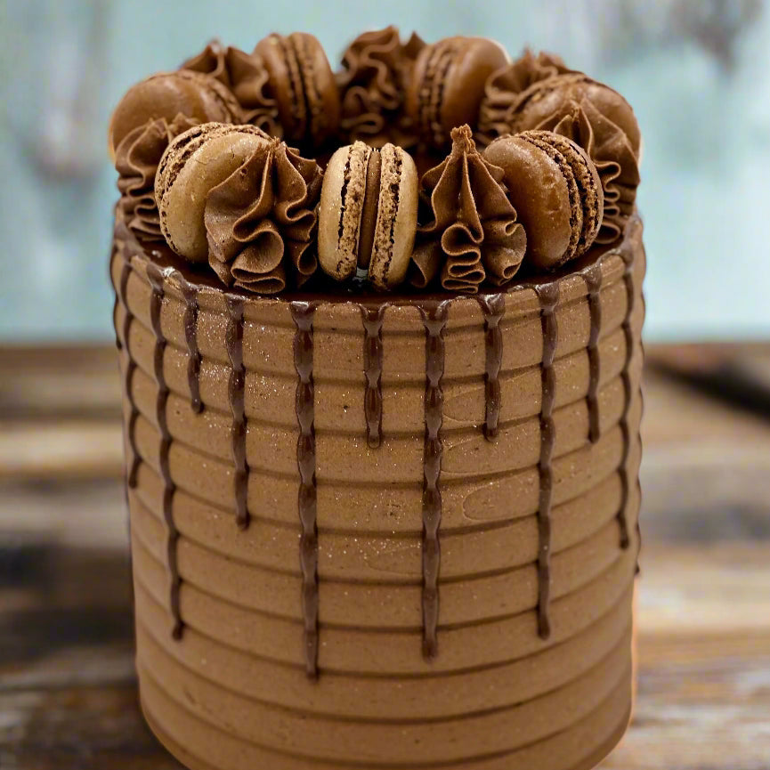 Front view of a chocolate macaron cake in Adelaide, showcasing its sophisticated chocolate styling and delicate macaron decorations.