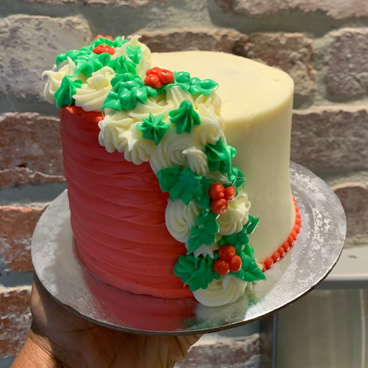 Full view of a tall Christmas mistletoe cake handcrafted in Adelaide using Ben & Jerry's ice cream, featuring elegant festive botanical decorations.