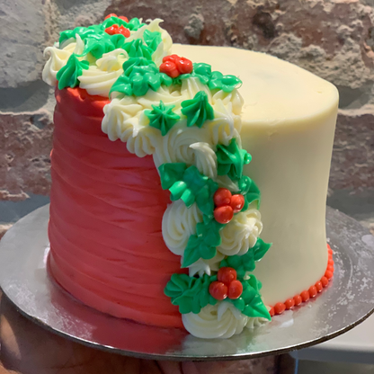 Front view of a tall mistletoe-themed Christmas cake made with Ben & Jerry's ice cream in Adelaide, showcasing its festive decorative styling.