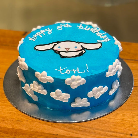 Full view of a Sanrio Cinnamoroll birthday ice cream cake featuring the adorable white puppy character in a kawaii-inspired design.