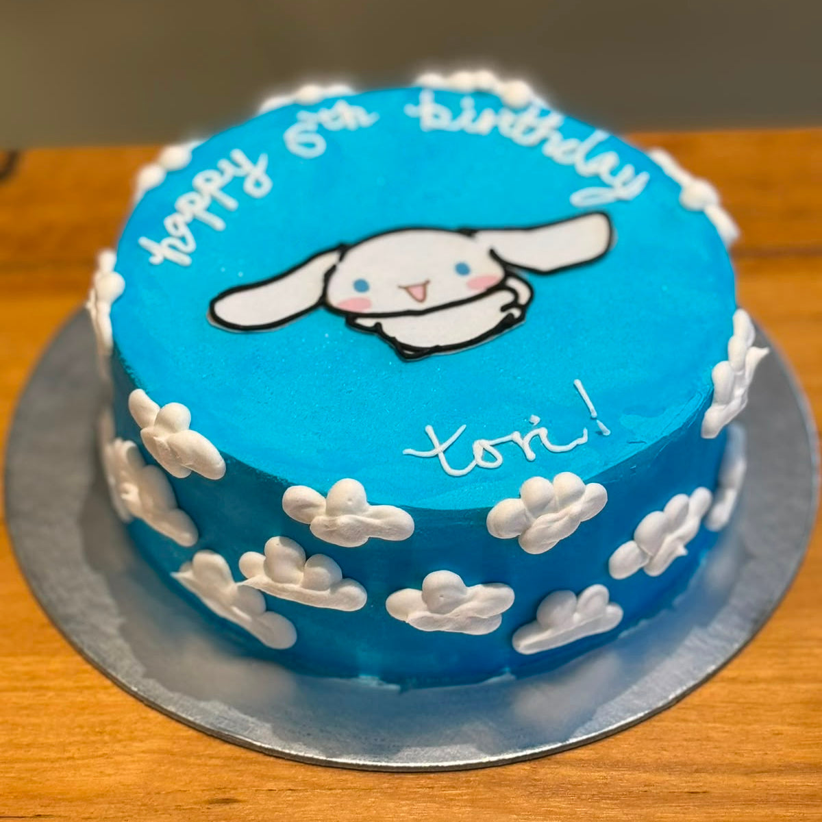 Front view of a handcrafted Cinnamoroll ice cream cake showcasing the recognisable Sanrio character and its cute birthday styling.