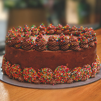Front view of a handcrafted chocolate celebration cake showcasing its classic chocolate-themed decorative finish.