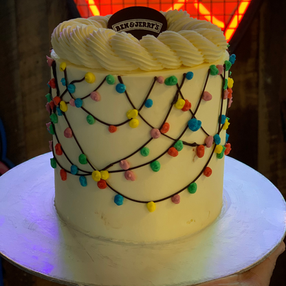 Full view of a Christmas holiday lights cake handcrafted in Adelaide using Ben & Jerry's ice cream, featuring colourful festive light-inspired decorations.