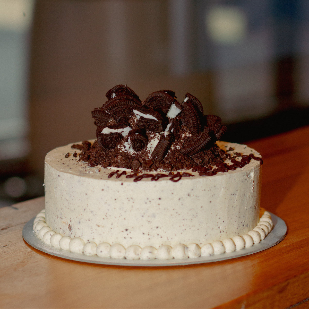 Full view of a cookies and cream birthday cake handcrafted in Adelaide using Ben & Jerry's ice cream, featuring a delicious cookie-inspired design.