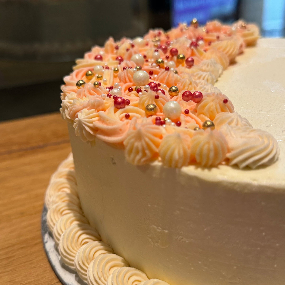 Close-up of the decorative finish on a crescent-shaped celebration cake handcrafted in Adelaide using Ben & Jerry's ice cream.