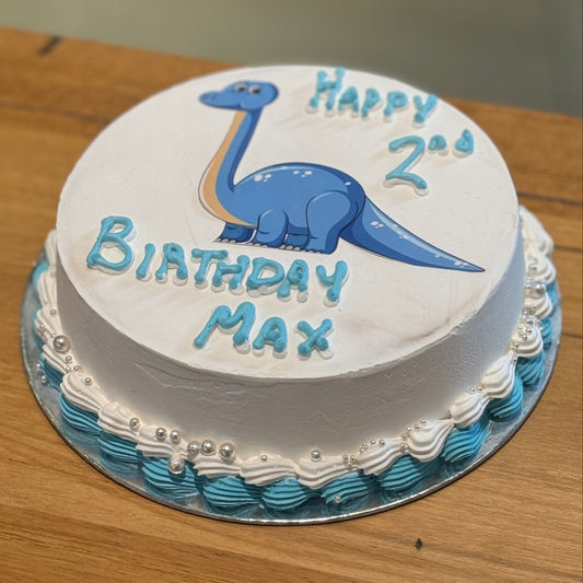 Full view of a dinosaur-themed birthday cake handcrafted in Adelaide using Ben & Jerry's ice cream, featuring playful prehistoric-inspired decorations.