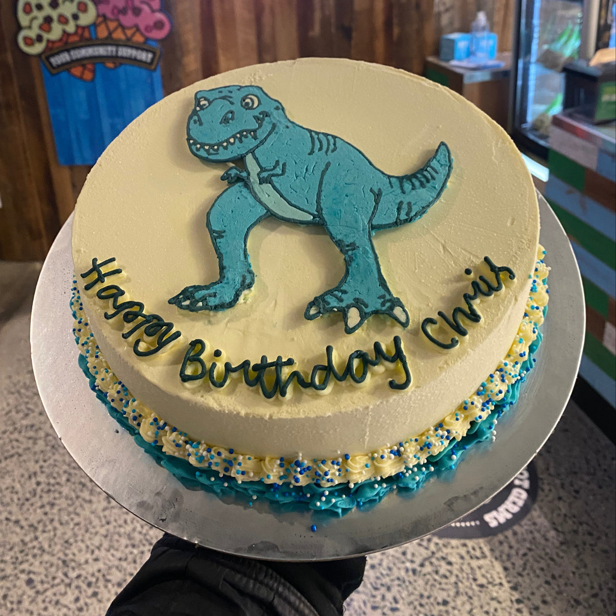 top view of a dinosaur birthday cake made with Ben & Jerry's ice cream in Adelaide, showcasing its fun dinosaur-inspired design.