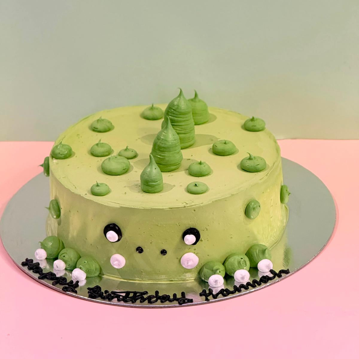 front view of a handcrafted dinosaur birthday cake made using Ben & Jerry's ice cream in Adelaide, highlighting its dinosaur-themed presentation.
