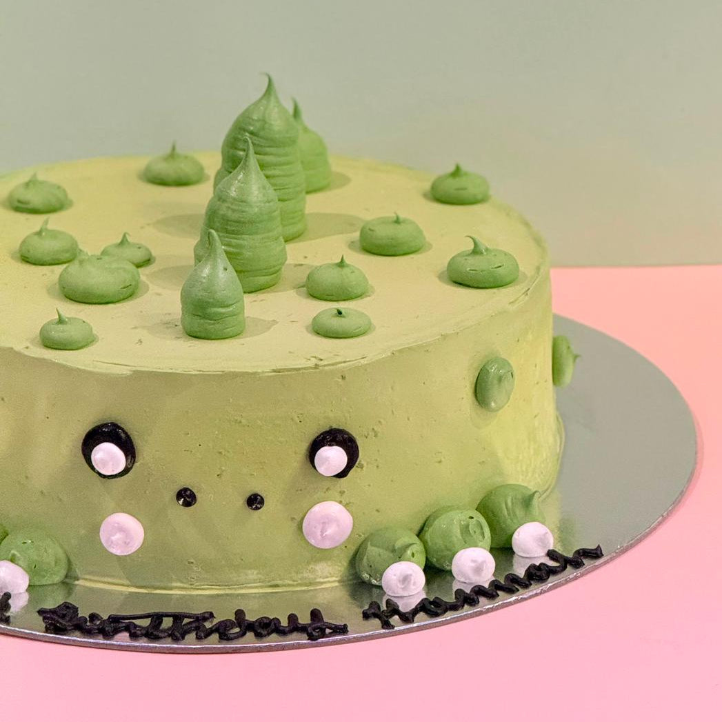 side view of the dinosaur-inspired decorative details on a children's birthday cake handcrafted in Adelaide using Ben & Jerry's ice cream.