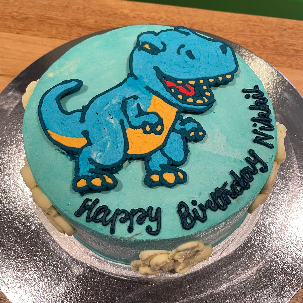 top view of the dinosaur-inspired decorative details on a birthday cake handcrafted in Adelaide using Ben & Jerry's ice cream.