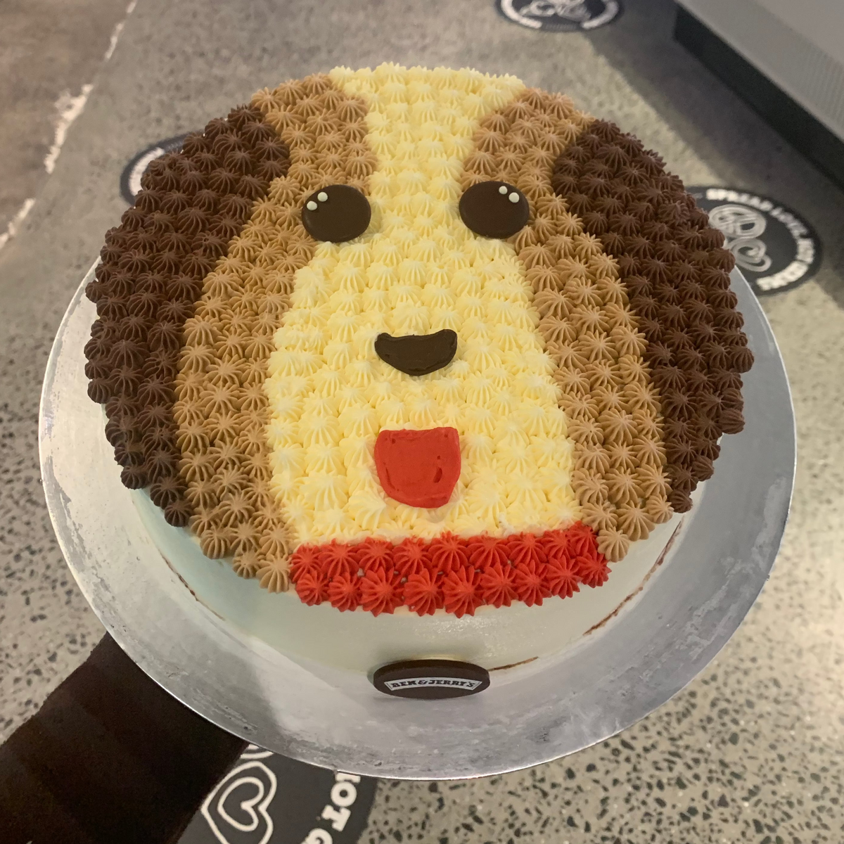 top view of a cute doggo birthday cake made with Ben & Jerry's ice cream in Adelaide, showcasing its charming canine-inspired presentation.