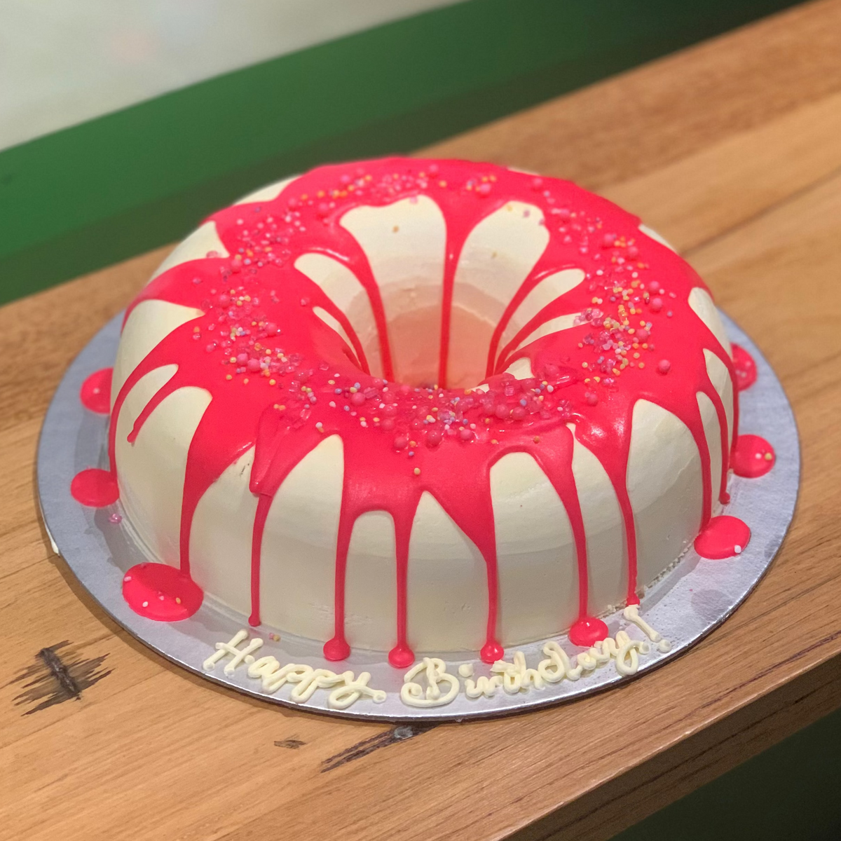 Full view of a donut-themed birthday cake handcrafted in Adelaide using Ben & Jerry's ice cream, featuring a playful donut-inspired design.