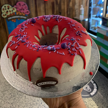 front of the donut-inspired decorative finish on a birthday cake handcrafted in Adelaide using Ben & Jerry's ice cream.